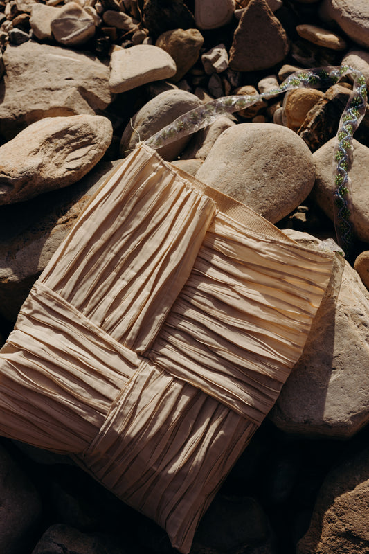 Textured beige fabric on a rocky surface